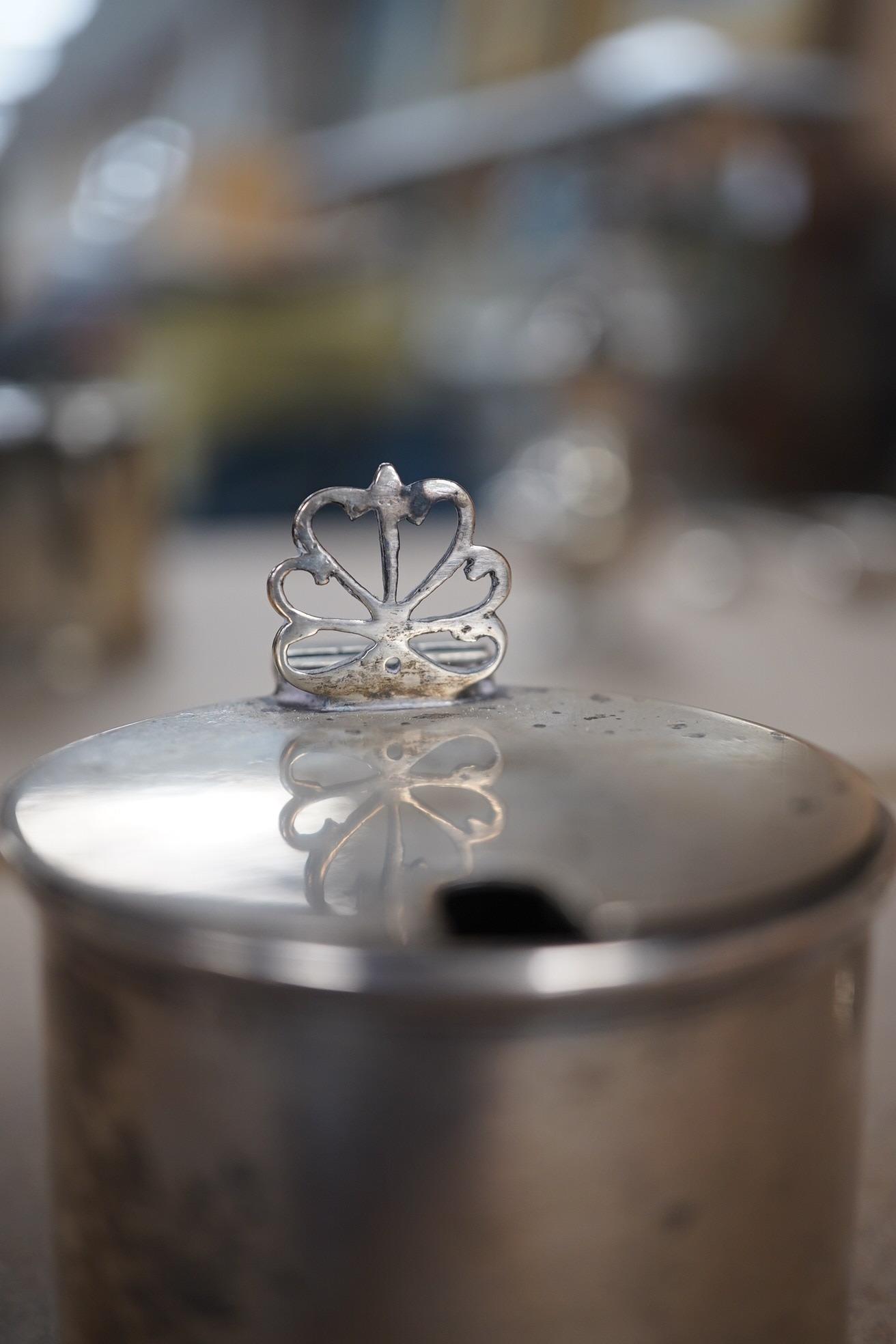 Sundry small silver including a pair of Edwardian silver drum mustards, London, 1907/8, 73mm, a Georgian pepperette, an Emes & Barnard pepperette, a Liberty & Co mustard pot, two other pepperettes and seven other items.